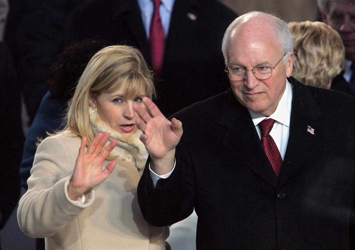Former U.S.Vice President Dick Cheney (R) and his daughter Liz watch the inaugural parade from the Presidential reviewing stand in front of the White House January 20, 2005 in Washington, DC.