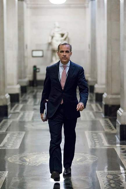 Mark Carney, the new Governor of the Bank of England, walks to a monetary policy committee (MPC) briefing on his first day on the job inside the central bank's headquarters in London Monday July 1, 2013.