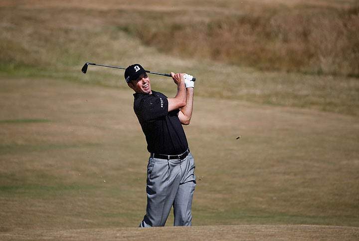 Matt Kuchar of the United States hits a shot on the 6th hole during the second round of the 142nd Open Championship at Muirfield on July 19, 2013 in Gullane, Scotland. (Photo credit: Rob Carr/Getty Images)