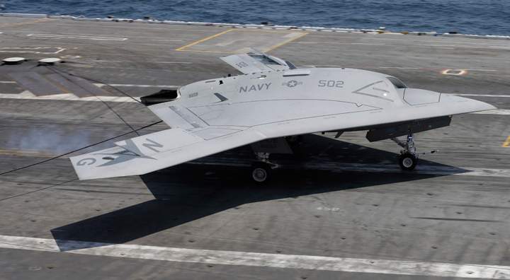 A X47-B navy drone grabs the wire as it lands aboard the nuclear aircraft carrier USS George H. W. Bush off the Coast of Virginia Wednesday, July 10, 2013. 