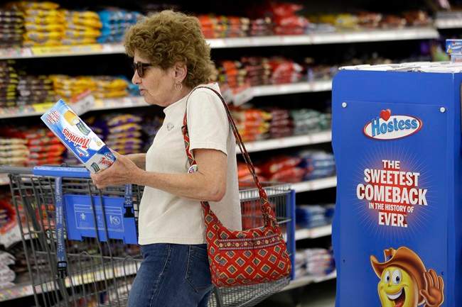 In this Friday, July 12, 2013, file photo Jo Mullen picks up a box of Twinkies at Wal-Mart, in Bristol, Pa.