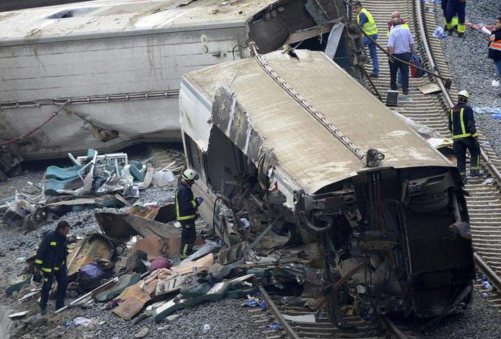 Rescuers check a car at the site of a train accident near the city of Santiago de Compostela on July 25, 2013.
