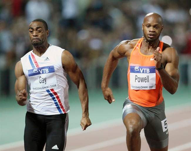 FILE - In this Sept. 12, 2009 file photo Tyson Gay, left, of the United States and Asafa Powell from Jamaica compete in men's 100 meters during an IAAF World Athletics Final at Thessaloniki's Kaftanzoglio stadium, Greece. 