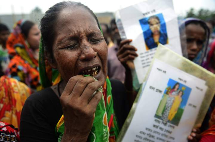 A mourner grieves for her missing relative following the April 24 Rana Plaza garment building collapse on the outskirts of Dhaka, on August 2, 2013. (Photo credit: Getty Images)