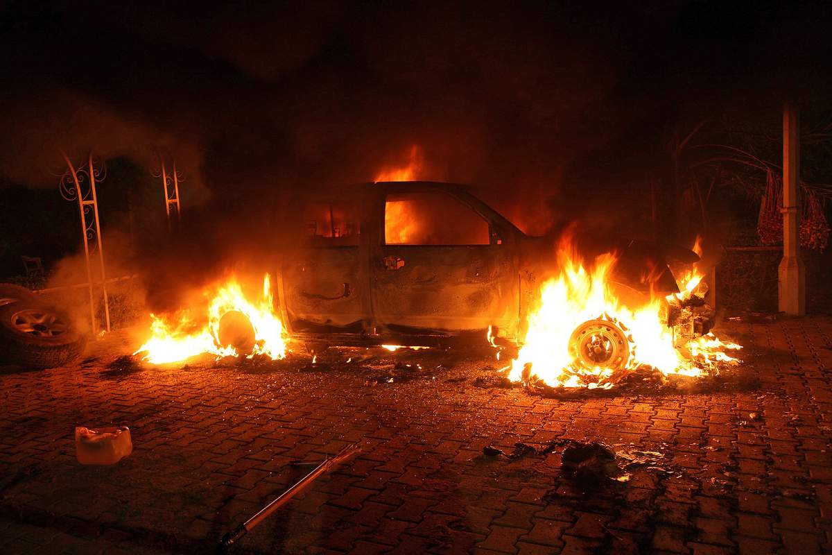 A vehicle and the surrounding area are engulfed in flames after it was set on fire inside the US consulate compound in Benghazi late on September 11, 2012. An armed mob protesting over a film they said offended Islam, attacked the US consulate in Benghazi and set fire to the building, killing one American, witnesses and officials said.