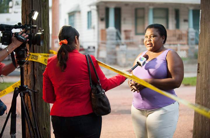An unidentified woman speaks to a reporter oustide the home of Ariel Castro on August 7, 2013 in Cleveland, Ohio. (Photo credit: Getty Images)