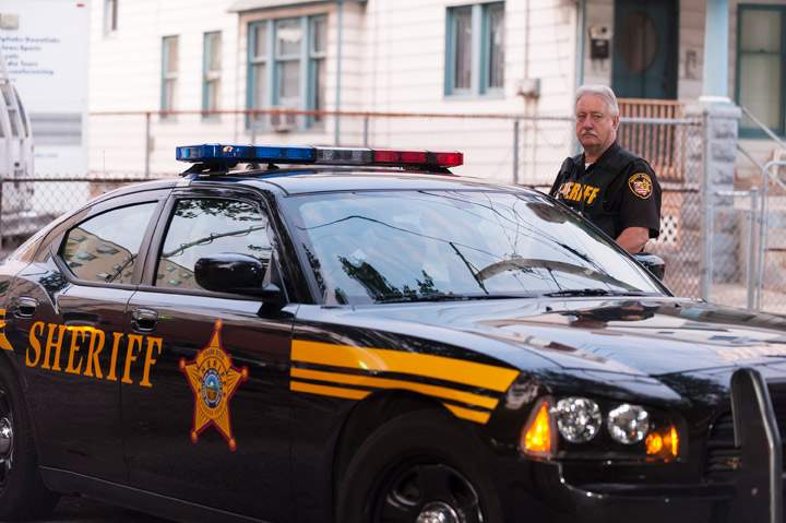 A member of The Cleveland Police Department blocks the road to Ariel Castro’s home on August 7, 2013 in Cleveland, Ohio. (Photo credit: Getty Images)
