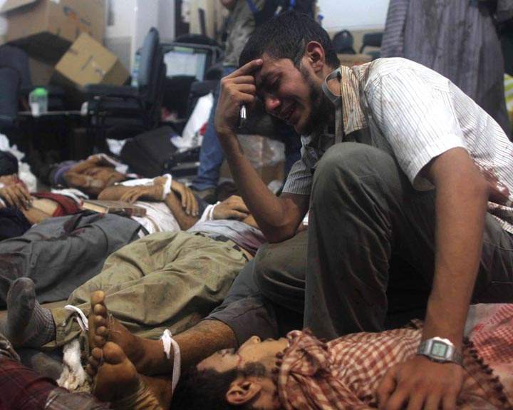 A man grieves as he looks at one of many bodies laid out in a makeshift morgue after Egyptian security forces stormed two huge protest camps at the Rabaa al-Adawiya and Al-Nahda squares where supporters of ousted president Mohamed Morsi were camped, in Cairo, on August 14, 2013. Mosaab El-Shamy/AFP/Getty Images