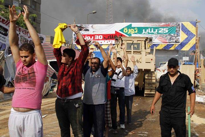 Egyptian security forces detain demonstrators after a crackdown on a protest camp by supporters of ousted president Mohamed Morsi and members of the Muslim Brotherhood on August 14, 2013 in Cairo's Rabaa al-Adawiya mosque. 