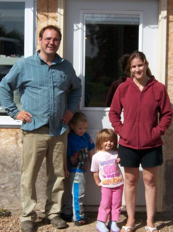 Alain and Karla Labrecque with their children Alec and Kandace, in front of their old farmhouse near Reno, Alberta in 2011. Photo courtesy of Karla Labrecque.