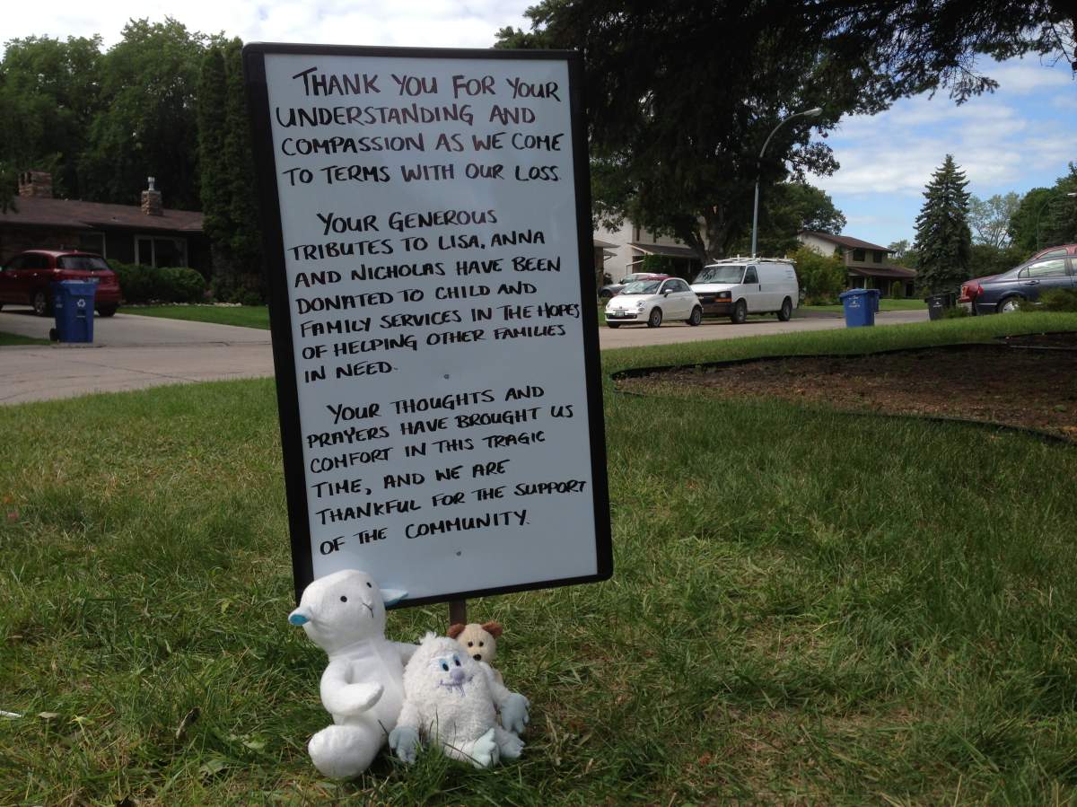 A sign informs people of what happened to an informal public memorial that had grown in the lawn of the Gibson family home.