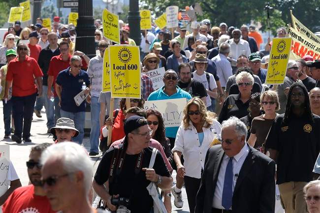 Protesters march in downtown Detroit Monday, Aug. 19, 2013.