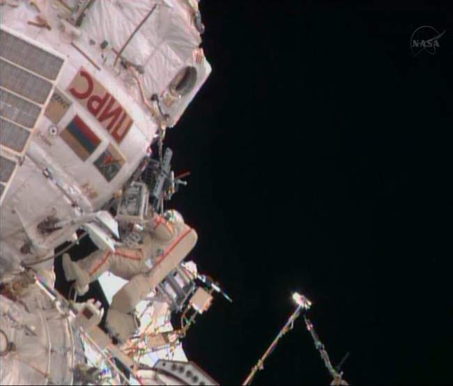 Russian cosmonaut Fyodor Yurchikhin approaches a hatch on the International Space Station, about 7 hours into a spacewalk with Aleksandr Misurkin on Friday, Aug, 16, 2013. 