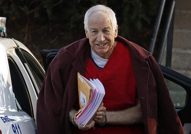 FILE - In this Jan. 10, 2013, file photo, former Penn State assistant football coach Jerry Sandusky arrives at the Centre County Courthouse for a post-sentencing hearing in Bellefonte, Pa. A lawyer says his client is the first to settle a civil claim against Penn State related to the Sandusky child sexual abuse case. Attorney Tom Kline confirmed in an email that the client known as Victim 5 when he testified at Sandusky's criminal trial has agreed to terms with the university. 