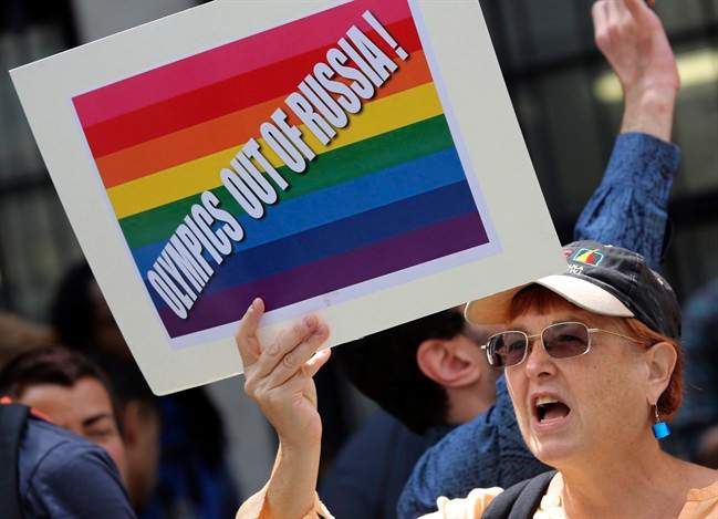 A gay rights activist chant slogans during a demonstration in front of the Russian consulate in New York, Wednesday, July 31, 2013.