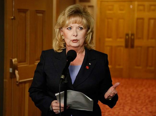 Senator Pamela Wallin speaks to reporters outside a Senate committee hearing on Parliament Hill in Ottawa on Monday, August 12, 2013. THE CANADIAN PRESS/ Patrick Doyle.