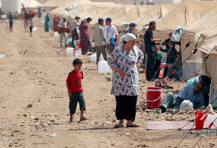 Syrian refugees wait for food aid at Kawergost refugee camp in Irbil, 217 miles (350 kilometers) north of Baghdad, Iraq, Wednesday, Aug. 21, 2013. (Photo credit: AP Photo)