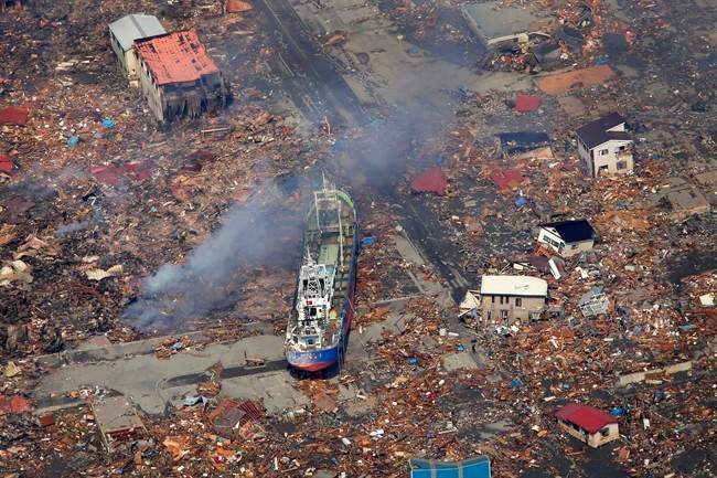 In this March 13, 2011 file photo, a ship washed away by a tsunami sits amid debris in Kesennuma, Miyagi Prefecture after Japan's biggest recorded earthquake hit its eastern coast. A new report suggests a similar scale quake on the B.C. coast could send Canadian economy into distress for years.