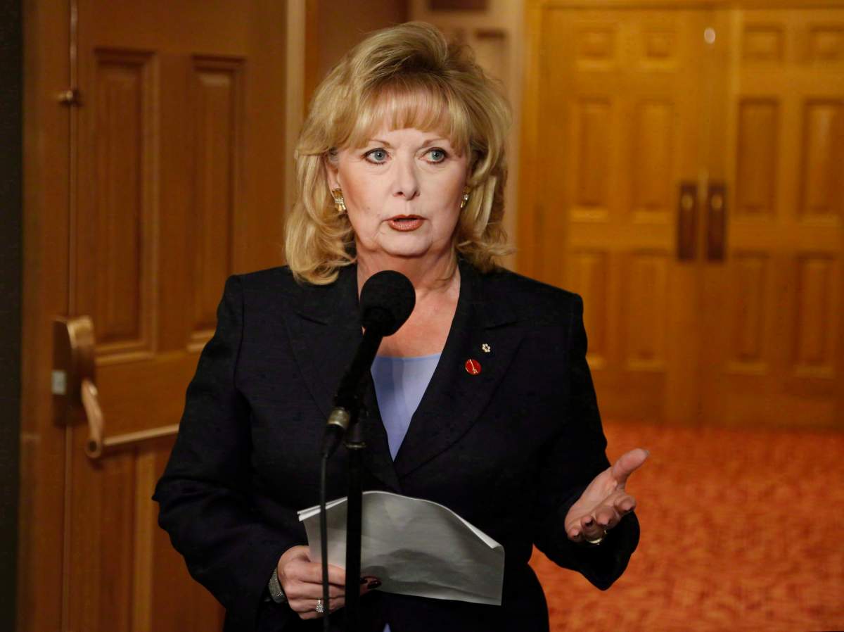 Senator Pamela Wallin speaks to reporters outside a Senate committee hearing on Parliament Hill in Ottawa on Monday, August 12, 2013. The embattled Saskatchewan senator and former Conservative caucus member has been ordered to pay back a grand total of $138,970. 