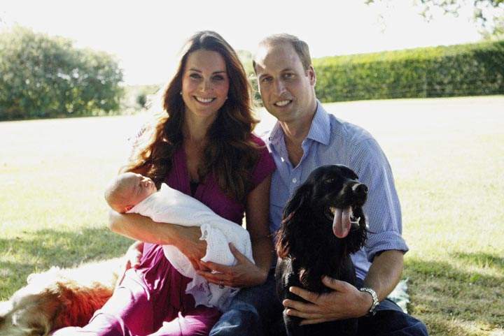 In this handout image provided by Kensington Palace, Catherine, Duchess of Cambridge and Prince William, Duke of Cambridge pose for a photograph with their son, Prince George Alexander Louis of Cambridge, surrounded by Lupo, the couple’s cocker spaniel, and Tilly the retriever (a Middleton family pet) in the garden of the Middleton family home in August 2013 in Bucklebury, Berkshire.