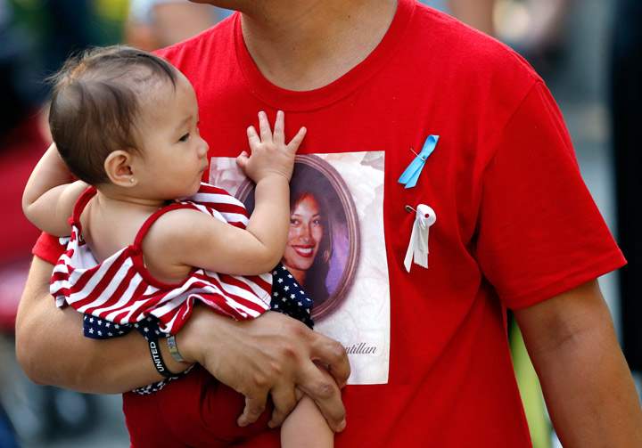 Friends and relatives of the victims of 9/11 terrorist attacks gather at the National September 11 Memorial at the World Trade Center site, Wednesday, Sept. 11, 2013, for a ceremony marking the 12th anniversary of the attacks in New York. (Photo credit: AP Photo)