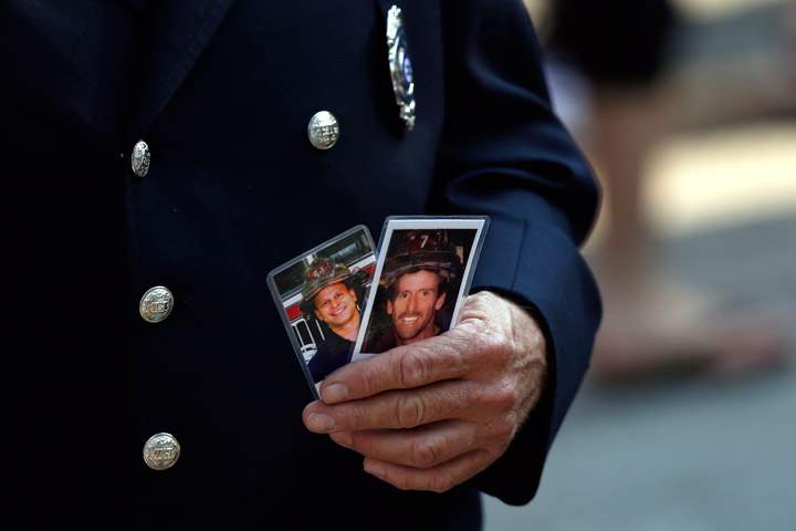 Friends and relatives of the victims of the 9/11 terrorist attacks gather at the National September 11 Memorial at the World Trade Center site, Wednesday, Sept. 11, 2013, for a ceremony marking the 12th anniversary of the attacks in New York. (Photo credit: AP Photo)