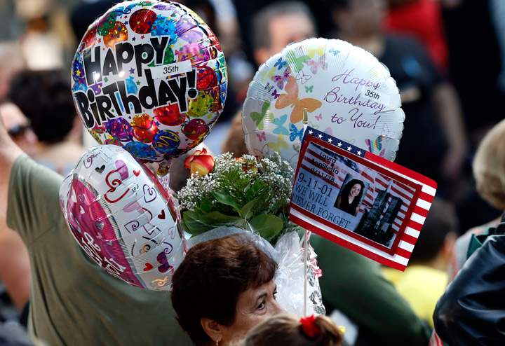 Friends and relatives of the victims of the 9/11 terrorist attacks gather at the National September 11 Memorial at the World Trade Center site, Wednesday, Sept. 11, 2013, for a ceremony marking the 12th anniversary of the attacks in New York. (Photo credit: AP Photo)