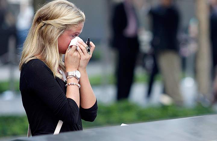 Kayla Fallon, daughter of William Fallon who perished in Tower One when she was 8 years old, reacts as she attends ceremonies for the twelfth anniversary of the terrorist attacks on lower Manhattan at the World Trade Center site on September 11, 2013 in New York City. (Photo credit: Getty Images)