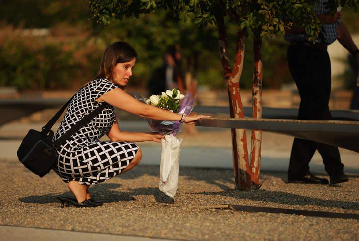 A family member of the victims of the September 11, 2001 attack on the Pentagon visits the memorial site before an observance ceremony at the Pentagon September 11, 2013 in Arlington, Virginia. (Photo credit: Getty Images)