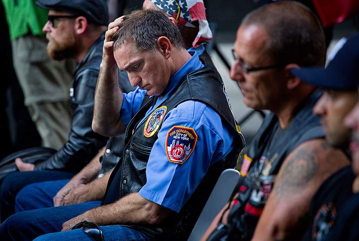 Retired FDNY Marshal Ernie Medaglia, of Bronxville, N.Y., who was at the attacks at the World Trade Center on Sept. 11, 2001, is emotional as he listens to New York Gov. Andrew Cuomo at a ceremony near the 9/11 Memorial honoring first responders and FDNY Rescue 1 on the 12th anniversary of the attacks on the World Trade Center in New York. (Photo credit: AP Photo)