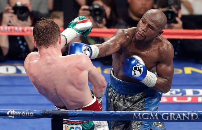 Floyd Mayweather Jr. throws a punch against Canelo Alvarez during a 152-pound title fight, Saturday, Sept. 14, 2013, in Las Vegas.