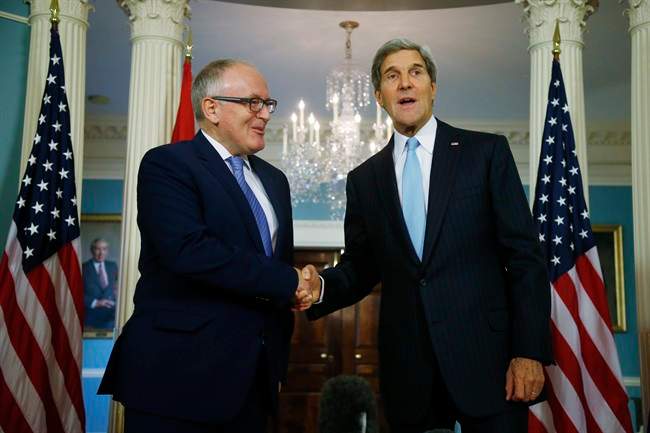 Secretary of State John Kerry and Dutch Foreign Minister Frans Timmermans shake hands after they made statements to reporters about efforts to disarm Syria of their chemical weapons at the State Department in Washington, Friday, Sept. 20, 2013. 