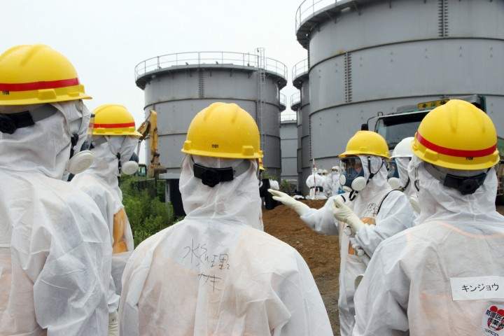 Japan's nuclear watchdog members, including Nuclear Regulation Authority members in radiation protection suits, inspect contaminated water tanks at the Tokyo Electric Power Co (TEPCO) Fukushima Dai-ichi nuclear power plant in the town of Okuma, Fukushima prefecture on August 23, 2013.