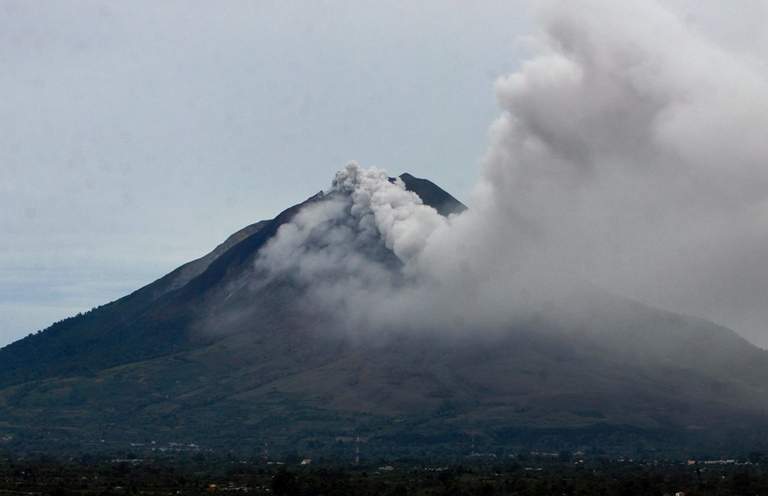 Sinabung volcano spews thick smoke and volcanic material in Indonesia's Karo district on September 15, 2013. Thousands of villagers fled the area on September 15 after a volcano erupted on Indonesia's Sumatra island, spewing rocks and red-hot ash onto surrounding villages, officials said. (KHARISMA TARIGAN/AFP/Getty Images).
