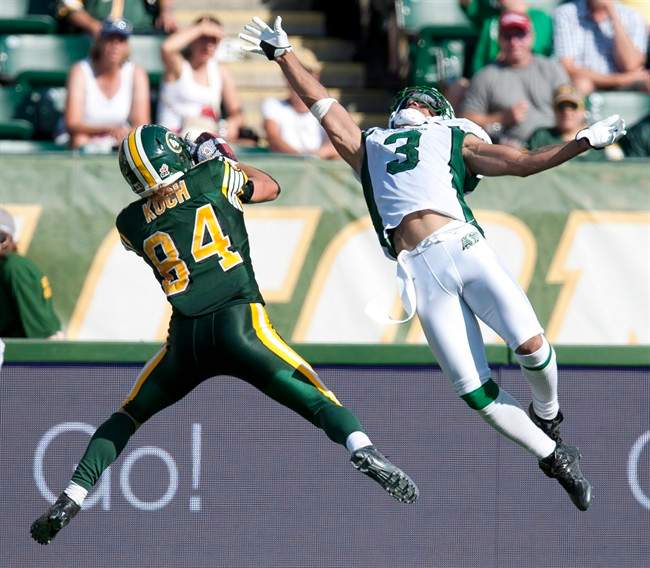 Saskatchewan Roughriders' Macho Harris, right, fails to block a pass to the Edmonton Eskimos' Cary Koch, during second half CFL football game action in Edmonton, Alta., on Saturday, August 24, 2013.