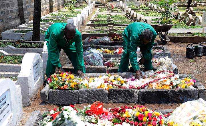 Workers at the Shia Imami Ismailia cemetry arrange flowers on September 26 ,2013 on the grave of Kenyan journalist Ruhila Adatia-Sood during her funeral ceremony in Nairobi.  (Photo credit: Getty Images)