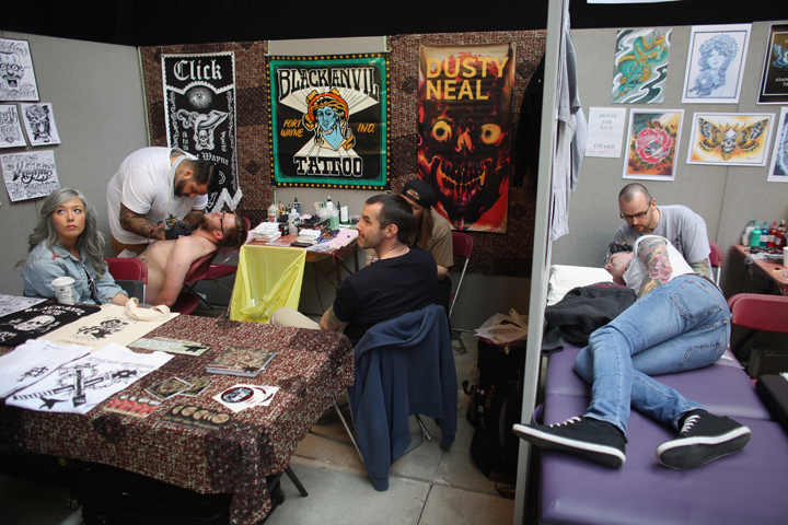 Body art enthusiasts receive tattoos at the London Tattoo Convention in Tobacco Dock on September 27, 2013 in London, England. Photo by Oli Scarff/Getty Images