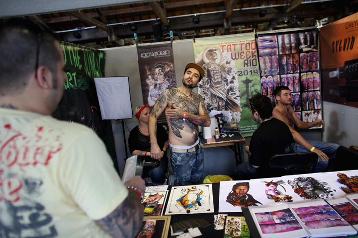 Tattoo artists prepare their stand at the London Tattoo Convention in Tobacco Dock on September 27, 2013 in London, England. Photo by Oli Scarff/Getty Images