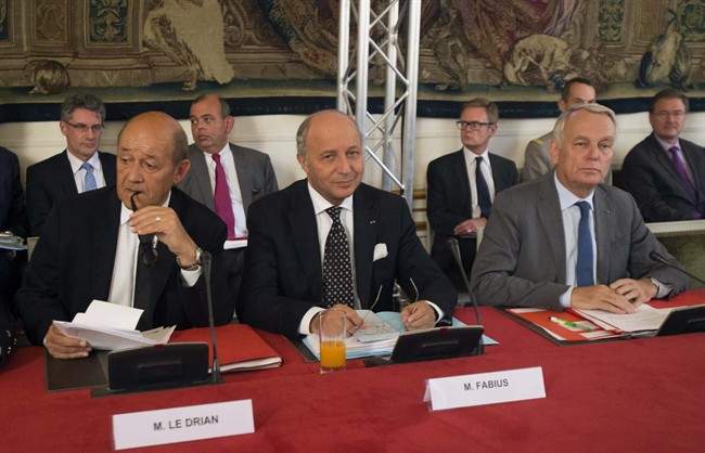 French Defense Minister Jean-Yves Le Driant, left, French Foreign Minister Laurent Fabius, center, and French Prime Minister Jean-Marc Ayrault, right, pose prior to a meeting at Matignon in Paris, Monday Sept. 2, 2013. 