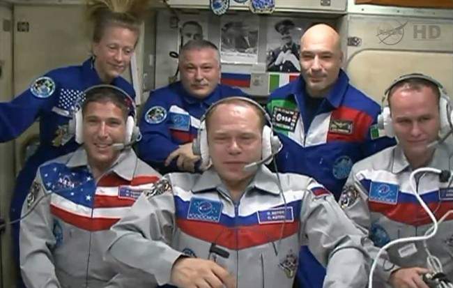 New Expedition 37 crew members, foreground from left: Mike Hopkins, Sergey Ryazanskiy and Oleg Kotov, were welcomed aboard the International Space Station Thursday Sept. 26, 2013.