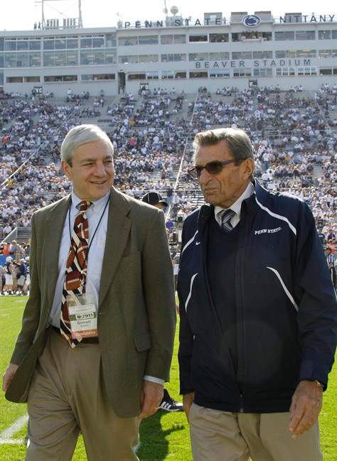 FILE - In this Oct. 8, 2011 file photo Penn State president Graham Spanier, left, and head football coach Joe Paterno talk before an NCAA college football game against Iowa in State College, Pa.