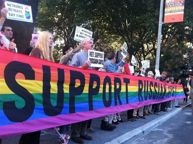 In this photo provided by Queer Nation NY, anti-Putin protestors demonstrate outside the Metropolitan Opera at Lincoln Center, Monday, Sept. 23, 2013, in New York.