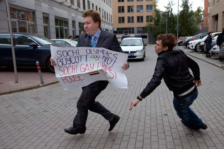 Russia’s leading gay rights campaigner Nikolai Alexeyev runs away from a plainclothes policeman during a protest outside the Sochi 2014 Winter Olympic Games organizing committee office, in downtown Moscow, Russia, on Wednesday, Sept. 25, 2013.
