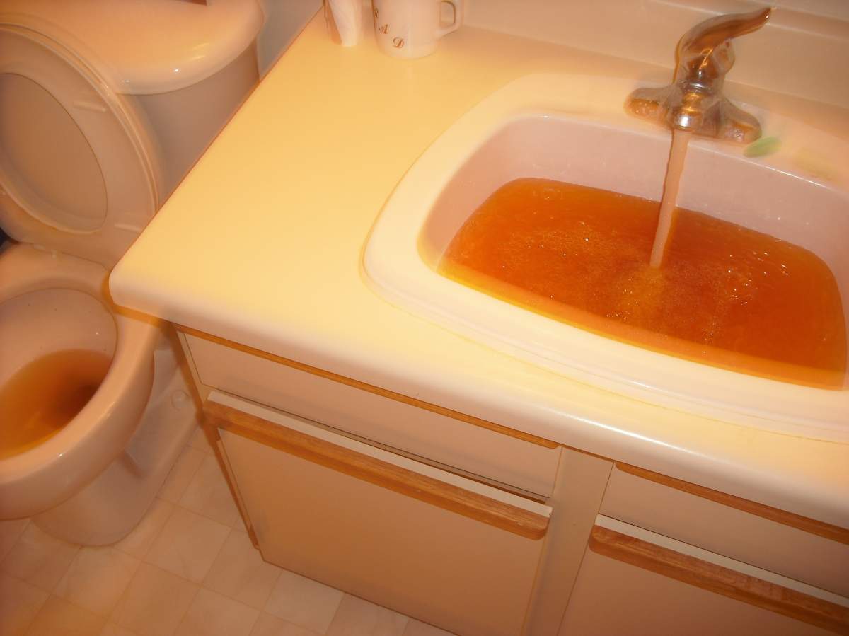 Brown water pours from a tap in Winnipeg in 2013. Parts of the West End, St. James and River Heights might experience brown water starting Tuesday as city staff inspects a feeder main.