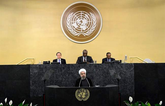 United Nations Secretary-General Ban Ki-moon, left, president of the 68th Session of the United Nations General Assembly John Ashe, center, and Under Secretary-General Tegegnework Gettu, right, are seated above as Iranian President Hassan Rouhani addresses a high-level meeting on Nuclear Disarmament during the 68th United Nations General Assembly on Thursday Sept. 26, 2013 at U.N. headquarters. 