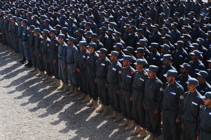 Members of the Afghan National Police (ANP) attend a graduation ceremony at a police training centre in Herat on October 10, 2013. Afghanistan forces, police and army, are due to take full security responsibility from their Western allies, a US-led NATO force, by the end of 2014. 