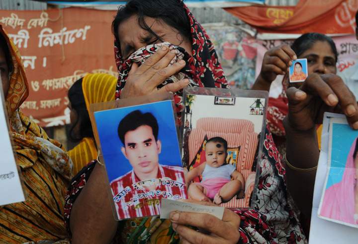 A mourner grieves for her missing relative during a memorial at the site of the Rana Plaza garment factory building collapse in Savar, on the outskirts of Dhaka on October 24, 2013, the six-month anniversary of the disaster. (Photo credit: Getty Images)