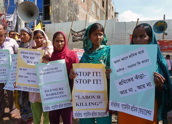 Bangladeshi garment workers demonstrate at the site of the Rana Plaza garment factory building collapse in Savar, the outskirts of Dhaka, on the six-month anniversary of the disaster. (Photo credit: Getty Images)
