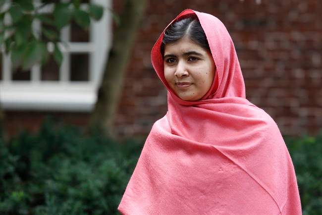 FILE - In this file photo taken Friday, Sept. 27, 2013, Malala Yousafzai listens as Harvard President Drew Gilpin Faust introduces her to reporters at Harvard University in Cambridge, Mass. 