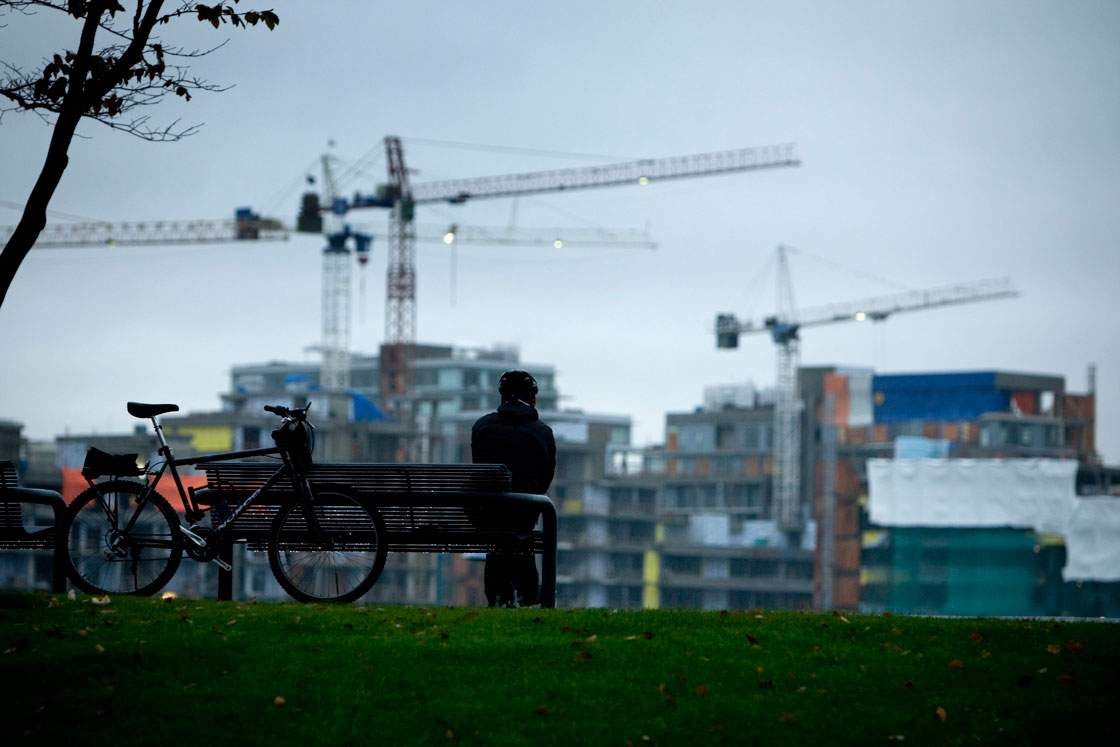Cranes sit atop condo developments along Toronto's waterfront. 